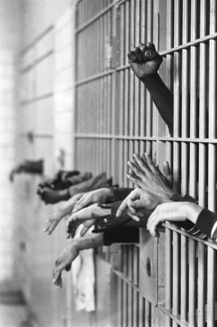 Jean-Pierre Laffont, Tomb Prison Hands from behind the bars, Turbulent America, Sous Les Etoiles Gallery