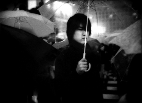 James Whitlow Delano, Mangaland, Under umbrella in nightime rain, Hachiko Shibuya, Tokyo, Japan, 2002, Sous Les Etoiles Gallery