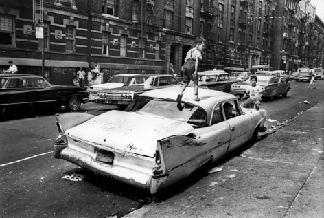 Jean-Pierre Laffont, Black Ghetto, kid walking on car, Bronx, 1966 Turbulent America, Sous Les Etoiles Gallery